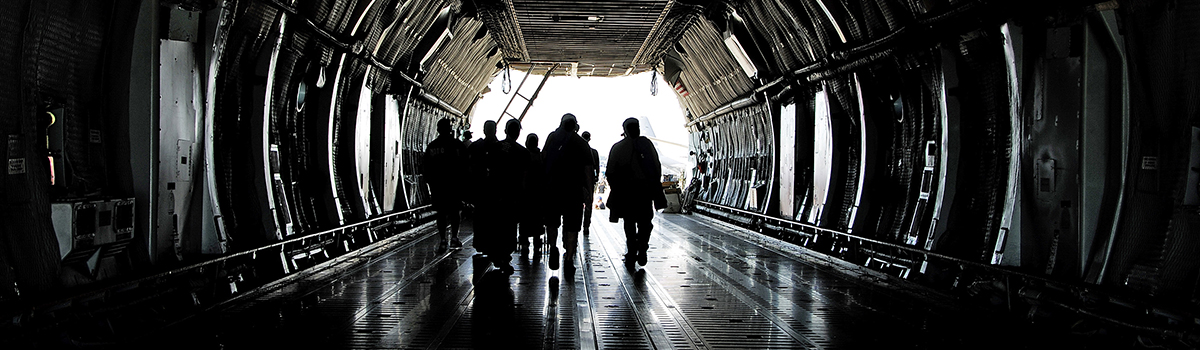 A group of people walking through an open door.